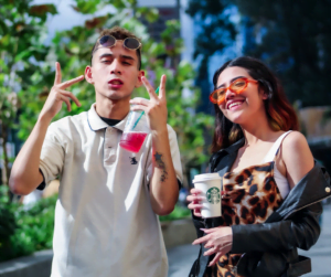 customers holding starbucks cups while taking a selfie