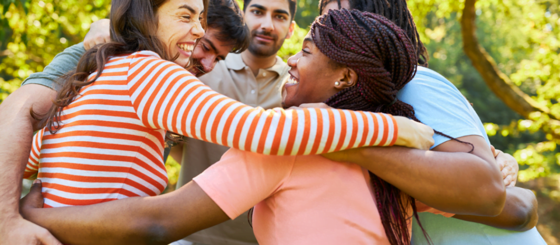 Employee Appreciation happy and diverse employees giving each other a group hug